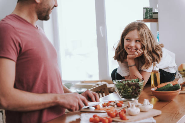 istock Adorable little girl spending time with father in kitchen 1132991034