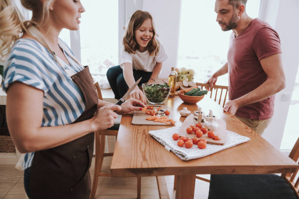 istock Happy family spending time together and cooking dinner 1132991043