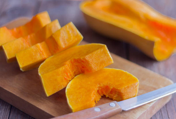 istock sliced pumpkin for cooking on wooden background 1132991706