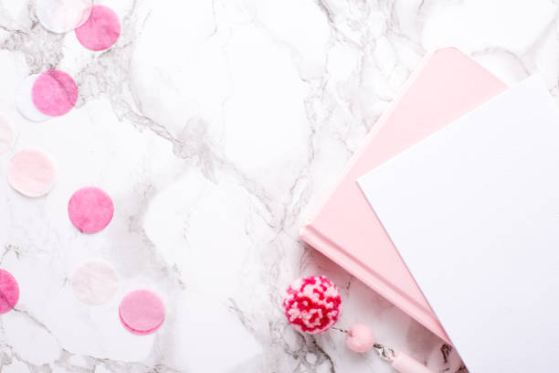 istock Present card and pink notebook on a marble background 1132994544