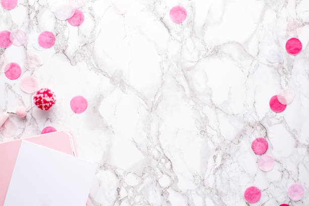 Present card and pink notebook on a marble background