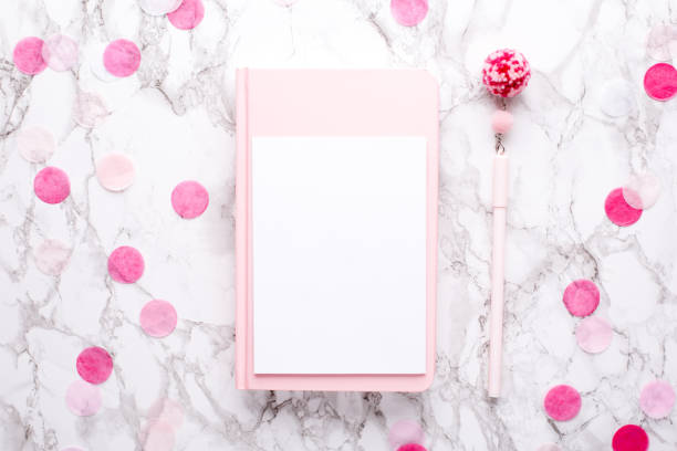 istock Present card and pink notebook on a marble background 1132994548