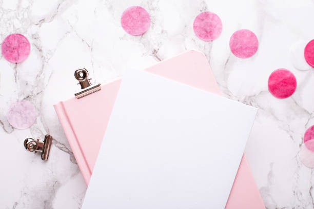 istock Present card and pink notebook on a marble background 1132994662