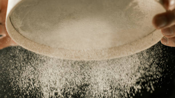 istock Flour sieve in male chef hands in the kitchen 1132994947