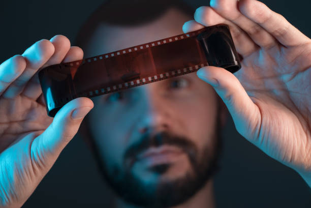 A man checks a film shot after development.