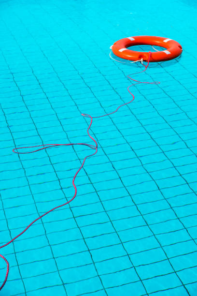 preservatori di vita di colore arancione galleggianti in piscina in grecia - life jacket life belt buoy float foto e immagini stock