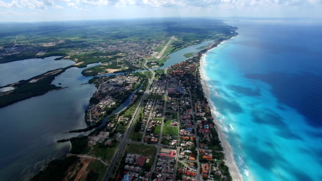 Drone flies above tropical island in the Atlantic Ocean. Bird's-eye view to Varadero's main streets, houses and coastline.