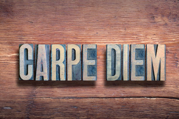 carpe diem - famous ancient Roman poet Horace quote with meaning - seize the day, made from wooden letterpress type on grunge wood