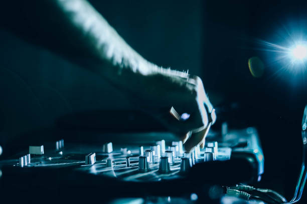 istock DJ controls the music console at a disco in the club. 1132997750