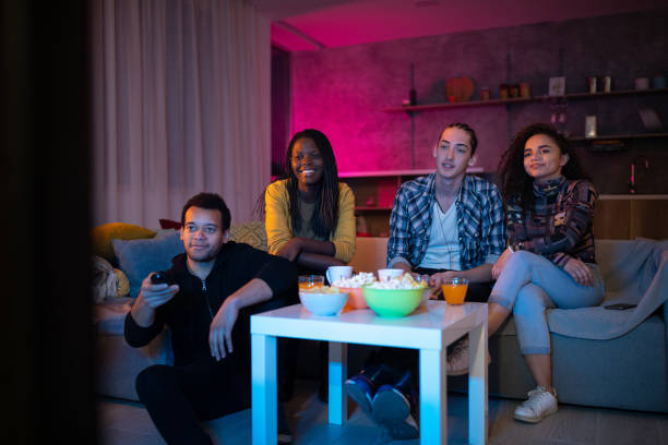 istock Roommates watching TV in living room 1132997966