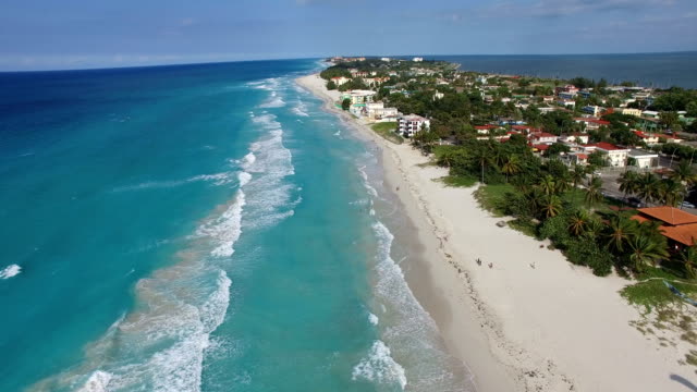 Drone is flying at tropical island in the Atlantic Ocean. Bird's-eye view to main streets, coastline and houses of Varadero.