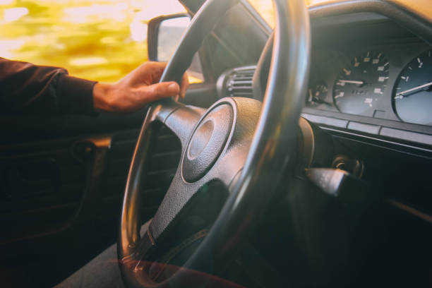 istock car driver holds the wheel on a sunny day. 1133001481