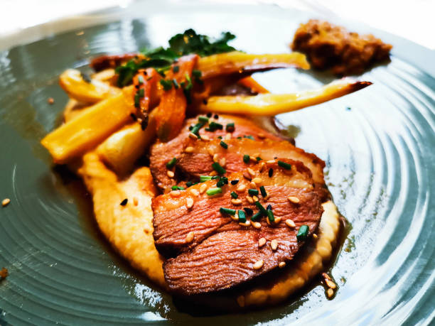 istock Tasty duck's tataki with smashed potatoes in blue ceramic plate for a gourmet lunch 1133001610
