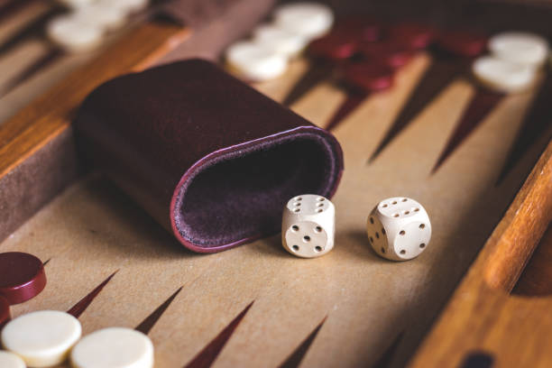 istock Playing backgammon game, dice on wooden board game. 1133002953