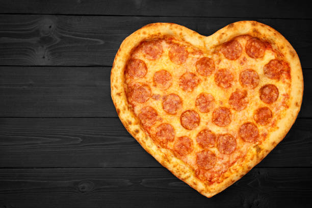 istock Pizza heart for Valentine's Day romantic concept copy space on rustic dark black background. Top View. Flat lay 1133003142