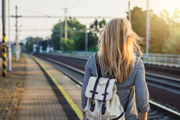 istock Woman waiting for train on railroad station. 1133005385