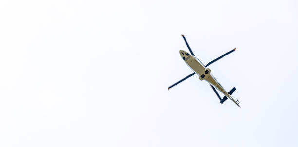istock Helicopter is flying on the sky, white clouds 1133006334