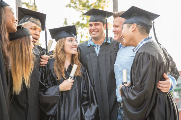 istock College students and friends after graduation ceremony. 1133007240