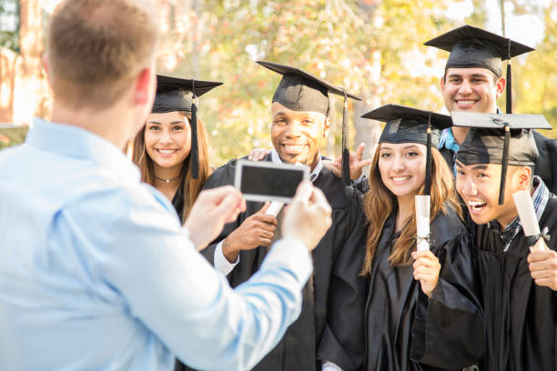 istock College students and father after graduation ceremony. 1133007290
