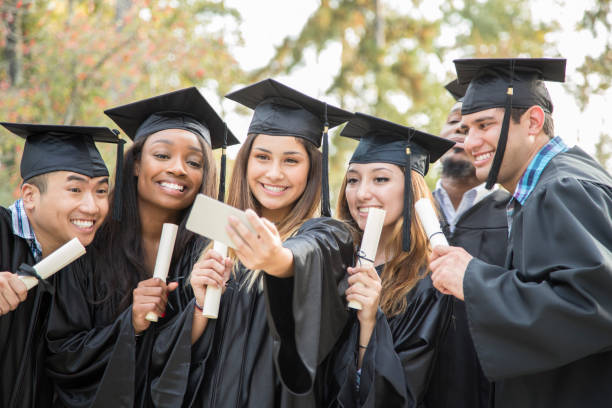 istock College student friends take selfie after graduation ceremony. 1133007310