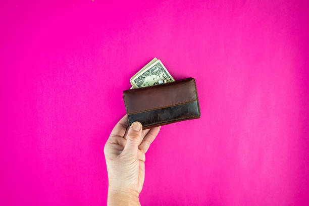 istock hand holds wallet with United States dollar 1133008841