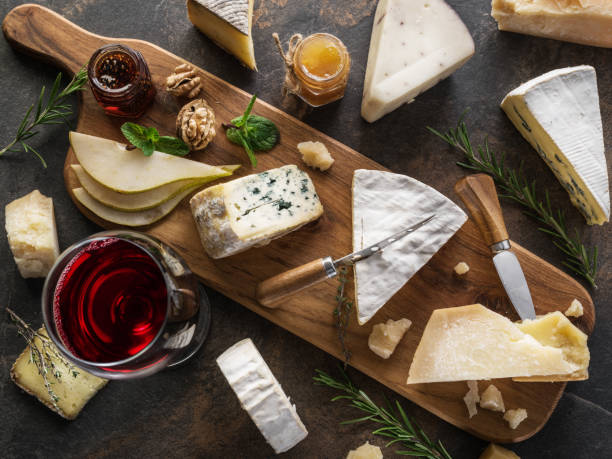 istock Cheese platter with different cheeses, fruits, nuts and wine on stone background. 1133008897