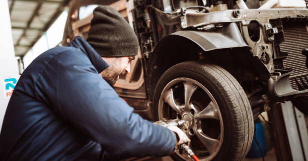istock mechanic at work changing the tire 1133009118