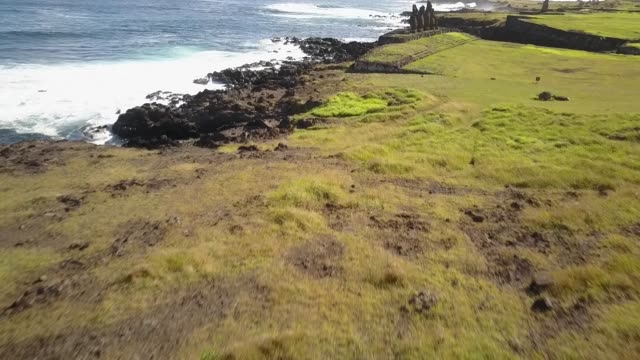 Aerial Footage over Ahu Vai Uri and Ahu Tahai Moais platforms at Easter Island. A close drone pass through the Moais statues and the coastline. Amazing the history behind the Moai and the traditions 1/5
