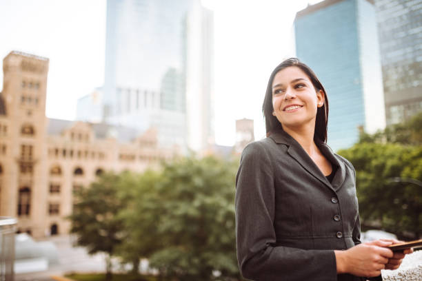 istock businesswoman text messaging in the city 1133010607