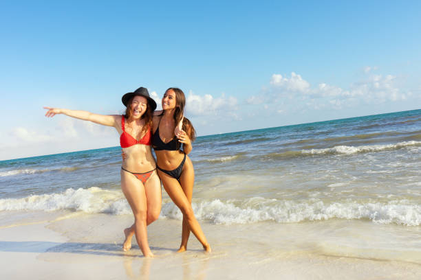 istock Two women friends enjoying at the beach 1133011292