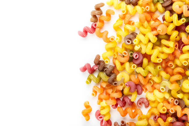 istock uncooked colorful pasta scattered on a white background. isolated. 1133011369