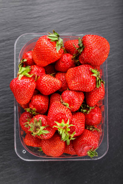 istock Fresh homemade strawberries on a black slate board 1133011457