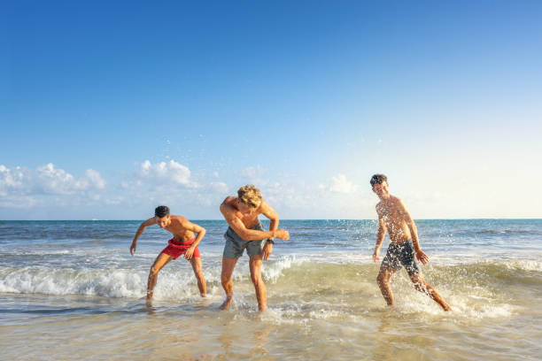istock Group of young men playing at the beach 1133012094