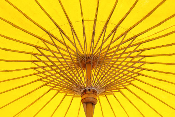istock Patterns of colorful under open yellow fabric umbrella texture structure abstract with reflection from the sun for background 1133015500