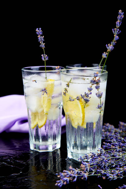 istock Lavender lemonade with lemon and ice on black background. 1133016871
