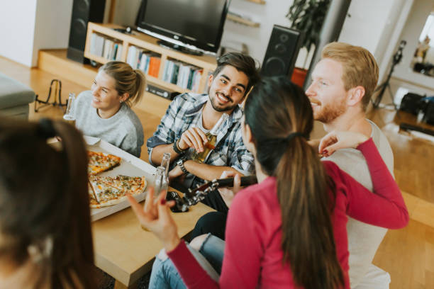 istock Young people having pizza party in the room 1133018115
