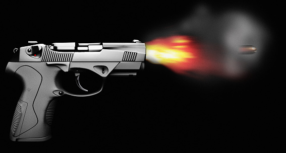 Pistol firing with bullet fire and smoke isolated on black side view