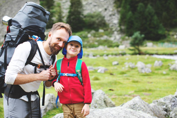 istock Father and son hiking together in mountains 1133021688