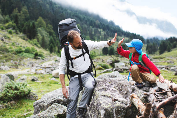 Father and son hiking together in mountains