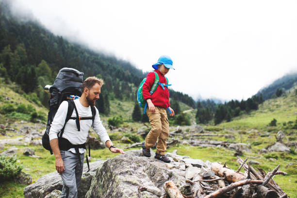 istock Father and son hiking together in mountains 1133021696