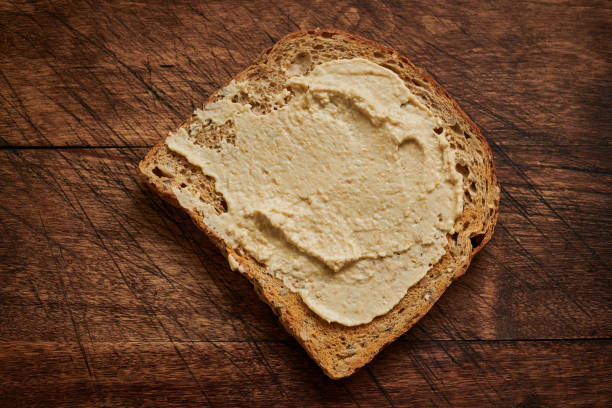 istock Slice of wholemeal toast spread with Hummus. 1133024110