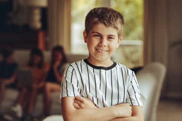 istock Kid standing at home with arms crossed 1133024178