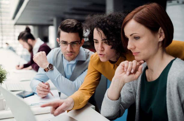 istock Group of young businesspeople working together in office, talking. 1133024196