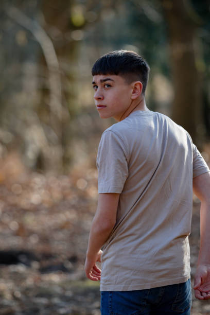 istock Teenage boy outside on a bright Spring day 1133026032