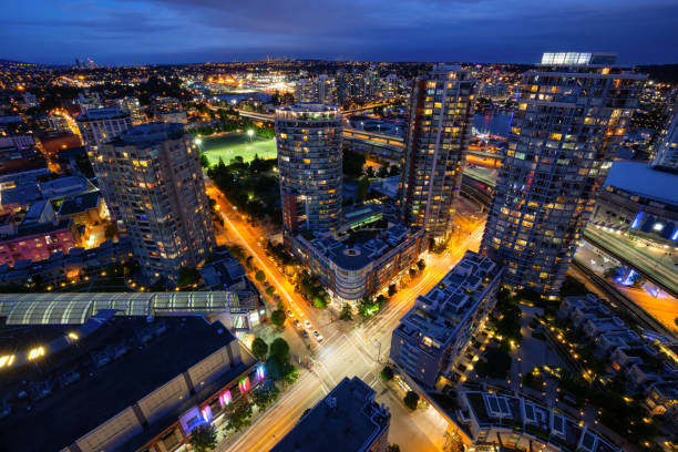 Downtown Vancouver Aerial Beautiful view of the modern cityscape from an aerial perspective at night. Taken in Downtown Vancouver, BC, Canada. vancouver at night stock pictures, royalty-free photos & images