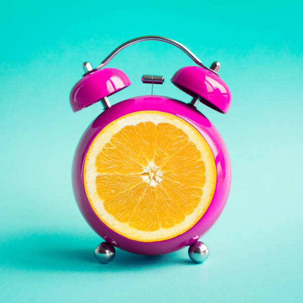 summer time concepts with orange alarm clock on blue pastel background. - clock time alarm clock orange imagens e fotografias de stock