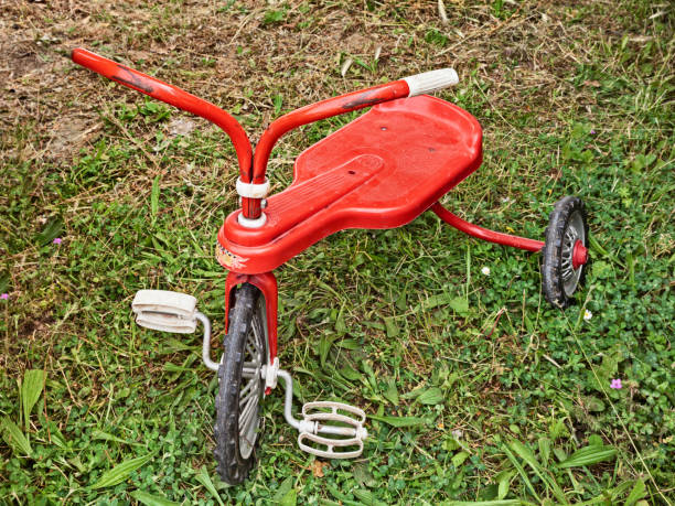 istock vintage toy, red old tricycle on the grass 1133027643