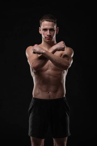 istock Wet young man crossed his fists, standing in a belligerent pose 1133027896