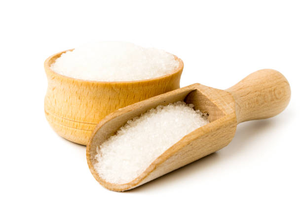 istock Sugar in wooden plate and spoon on white background. 1133028900