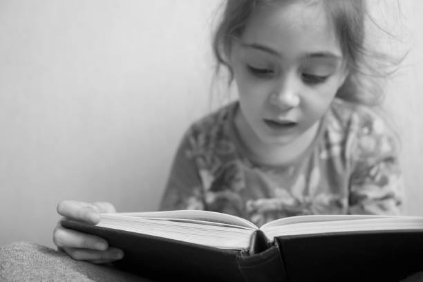 istock Little girl reading a book 1133028945